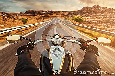 Driver riding motorcycle on asphalt road Stock Photo