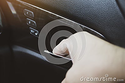 The driver`s hand unlocks the door handle Stock Photo