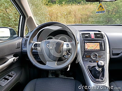 Driver seat view over car dashboard, touchscreen navigation display, manual gear transmission Editorial Stock Photo