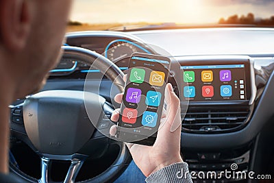 Driver uses a mobile phone with smart driving assistance apps Stock Photo