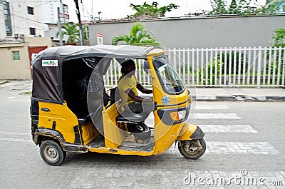 Drivers of yellow tuk tuks ply their trade around the port city Editorial Stock Photo