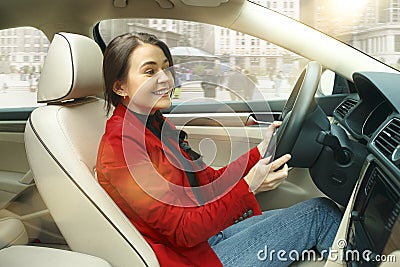 Driving around city. Young attractive woman driving a car Stock Photo