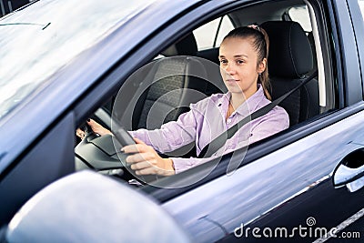 Driving car. Happy woman. Female taxi cab driver. Vehicle rent or sale business, dealership, chauffeur or rideshare service. Stock Photo