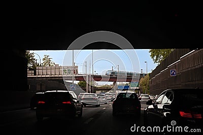 Exiting the tunnel at the wheel with a train running on a bridge Editorial Stock Photo