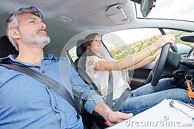 Driving instructor with female student Stock Photo