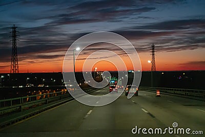 Driving over a bridge early morning at sunrise Stock Photo