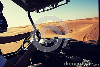 Driving quad baggi bike at desert dunes Stock Photo