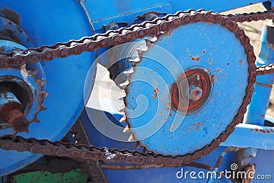 Driving roller chain on the drive sprocket in operation Stock Photo