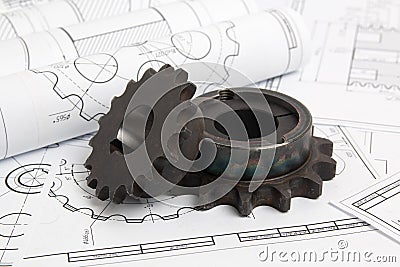 Driving sprockets and engineering drawings of industrial parts Stock Photo