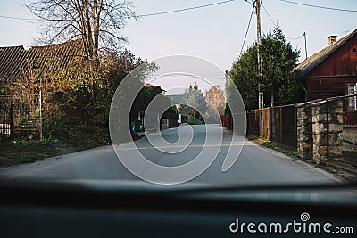 Driving through the town or village, view from the car Stock Photo