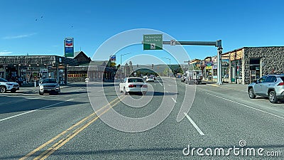 Driving through the town of West Yellowstone, MT on a sunny day Editorial Stock Photo
