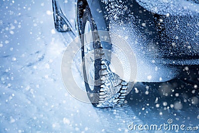 Driving in Winter - Car`s tyres and snowfall Stock Photo