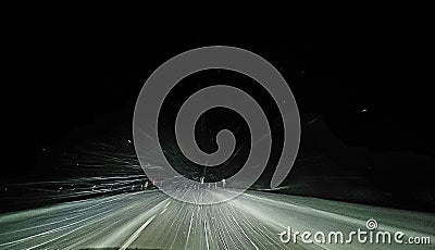 Driving in the winter nightime snow Stock Photo