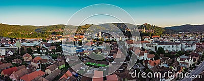 Drone aerial evening panorama of Sighisoara, Romania with Citadel and Biserica din Deal rising above the skyline. View towards the Stock Photo