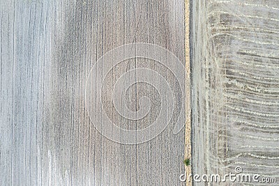 Drone aerial photography concept of abstract texture of plowed agriculture field and already harvested wheat grains Stock Photo