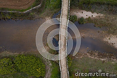 Drone aerial top above view of an ancient historic stone bridge in Idanha a velha, Portugal Stock Photo