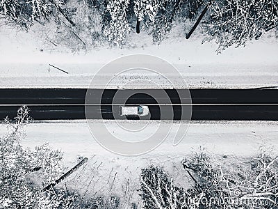 Drone aerial view of road in the snowy forest Stock Photo