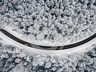 Drone aerial view of road in the snowy forest Stock Photo