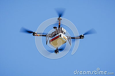 Drone carrying package Stock Photo