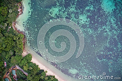 Drone field of view of fishing boats and pristine coastline and forest Praslin, Seychelles Stock Photo