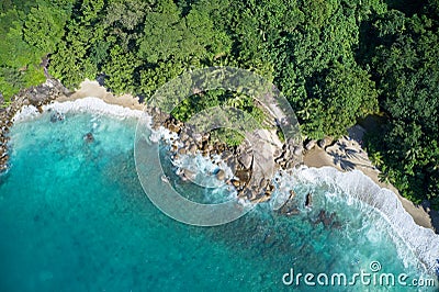 Drone field of view of secret cove with turquoise blue water meeting the forest on secluded island of Mahe, Seychelles Stock Photo