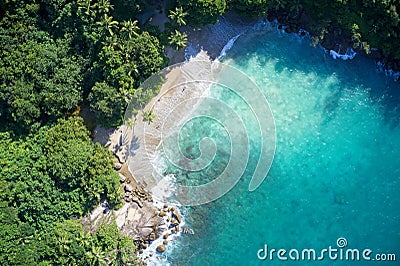 Drone field of view of secret cove with turquoise blue water meeting the forest on secluded island of Mahe, Seychelles Stock Photo