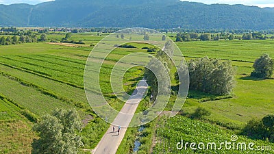 DRONE: Flying above a group of road cyclists riding their bikes down the road. Editorial Stock Photo