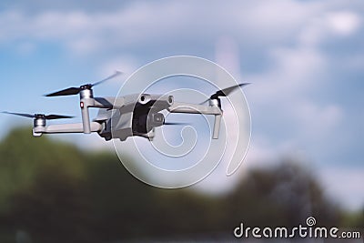 Drone flying in a city park. DJI Mavic Air 2 in the air at Munich Olympiapark. Editorial Stock Photo