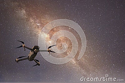 Drone flying in starry night sky showing the galaxy and stars Stock Photo