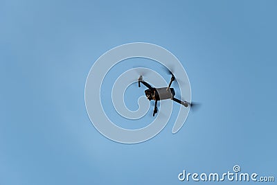 Drone flying taking videos of unsuspecting people Stock Photo