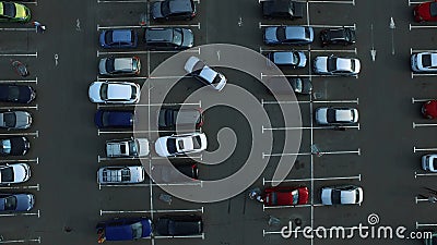 Drone footage cars parking at congested parking lots. people walking parking Stock Photo