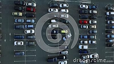 Drone footage people moving at parking. Aerial view car leaving parking Stock Photo