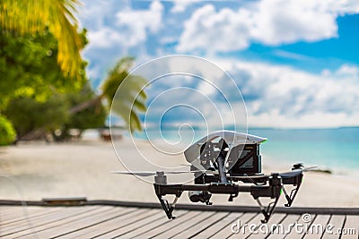 Drone making video footage and taking photographs on a tropical beach scene Stock Photo