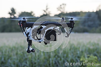 Drone at nightfall copter with camera flying at dawn. Quadrocopter drone. Stock Photo