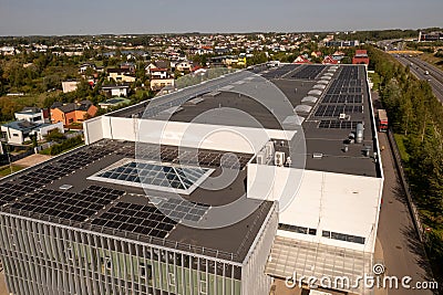 Drone photography of large logistical warehouse and office rooftop with solar energy modules Editorial Stock Photo