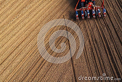 Drone pov tractor sowing corn in field Stock Photo