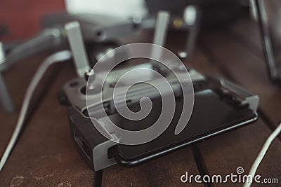 Drone quadcopter with a flight controller and notebook on the old wooden table. Stock Photo