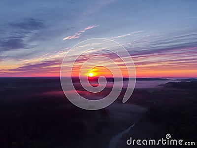 Drone's Eye View: Serene Sunrise Over Misty River and Woodland Landscape Stock Photo