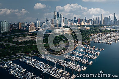 Drone shot of the Burnham Harbor full of parked boats with the beautiful cityscape of Chicago, USA Stock Photo