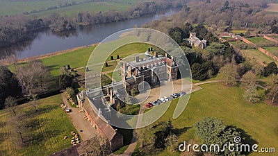 Drone shot of the National trust Sudbury Hall with the reflective river flowing nearby Stock Photo