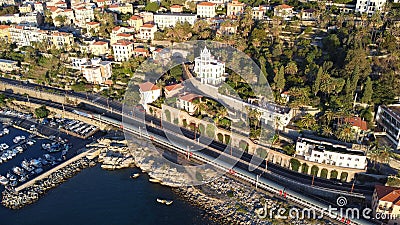 Drone shot of the rocky coast of the Bordighera, Italy with boats on its harbor Stock Photo