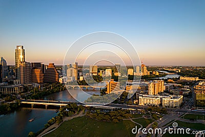 Drone shot of TX skyline with waterfront, greenery and blue sky at sunset in Austin city Stock Photo