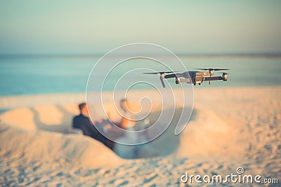 Drone taking footage and images of wedding couple at the beach Stock Photo