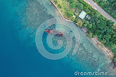 Drone view of abandoned broken sunken old ship that ran aground. Tropical coast of Sanma, Vanuatu Stock Photo
