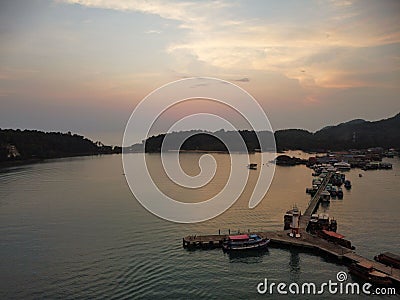 Drone view of the Bang Bao Pier in Koh Chang, Thailand at sunset with forests in the background Stock Photo