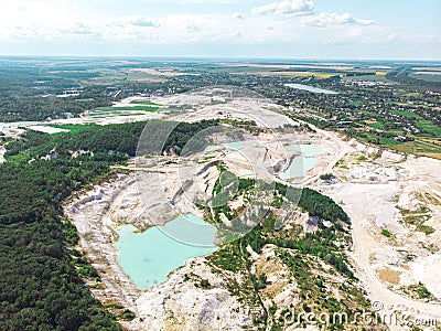 Drone view on a flooded kaolin quarry with turquoise water and white shore. Aerial shot of a kaolin pit flooded with water Stock Photo