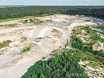 Drone view on a flooded kaolin quarry with turquoise water and white shore. Aerial shot of a kaolin pit flooded with water Stock Photo