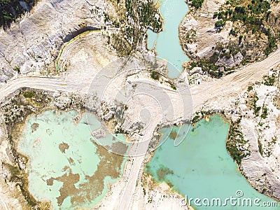Drone view on a flooded kaolin quarry with turquoise water and white shore. Aerial shot of a kaolin pit flooded with water Stock Photo