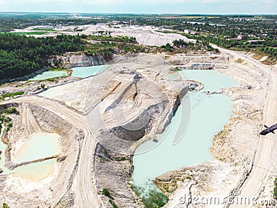 Drone view on a flooded kaolin quarry with turquoise water and white shore. Aerial shot of a kaolin pit flooded with water Stock Photo