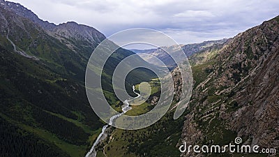 Drone view of a green gorge with high rocky cliffs Stock Photo